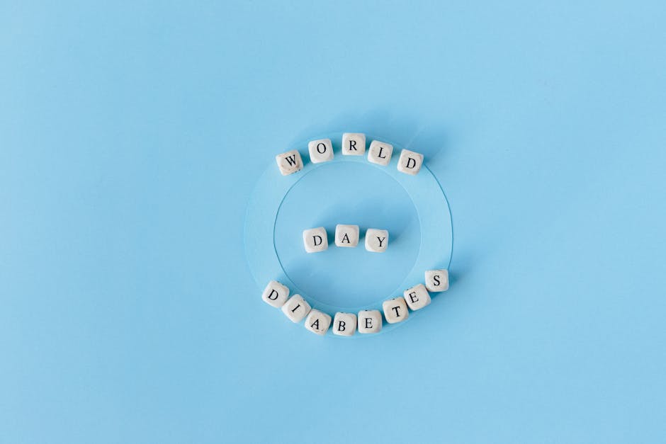 Creative World Diabetes Day concept with beads on blue background.