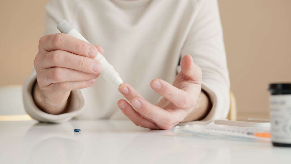 Close-up of a person using a glucometer to test blood sugar at home.
