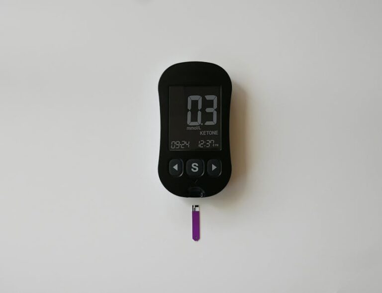 A close-up of a digital ketone meter displaying readings, ideal for health and wellness themes.