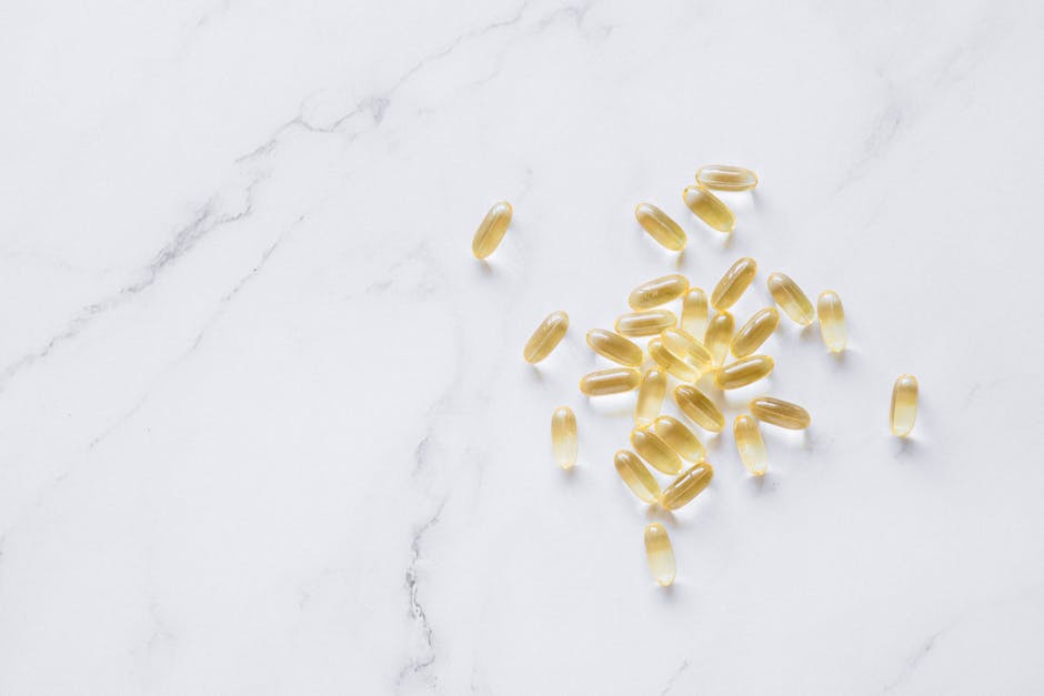 A group of translucent capsules arranged on a marble surface, offering a minimalist aesthetic.
