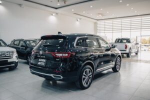 Spacious modern showroom featuring luxury cars on display.