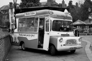 Black and white photo of a classic ice cream van parked in Rochester, England.