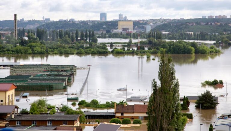 Aerial shot of a city affected by severe flooding with submerged buildings and roads.