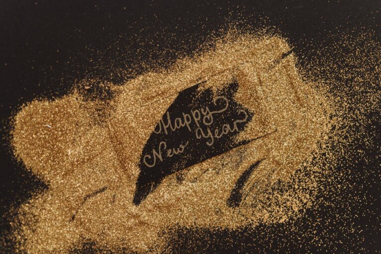 A festive greeting with glitter and cursive lettering spelling 'Happy New Year'. Perfect for seasonal celebrations.